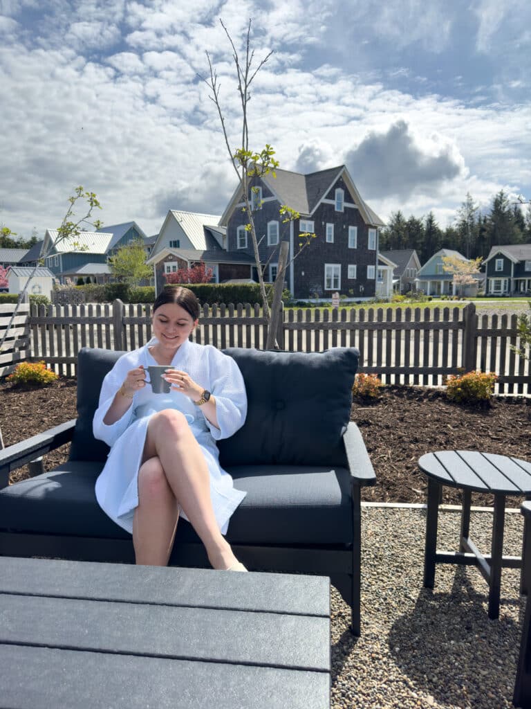 Author Lauren T sitting outside her rental cabin in Seabrook, WA