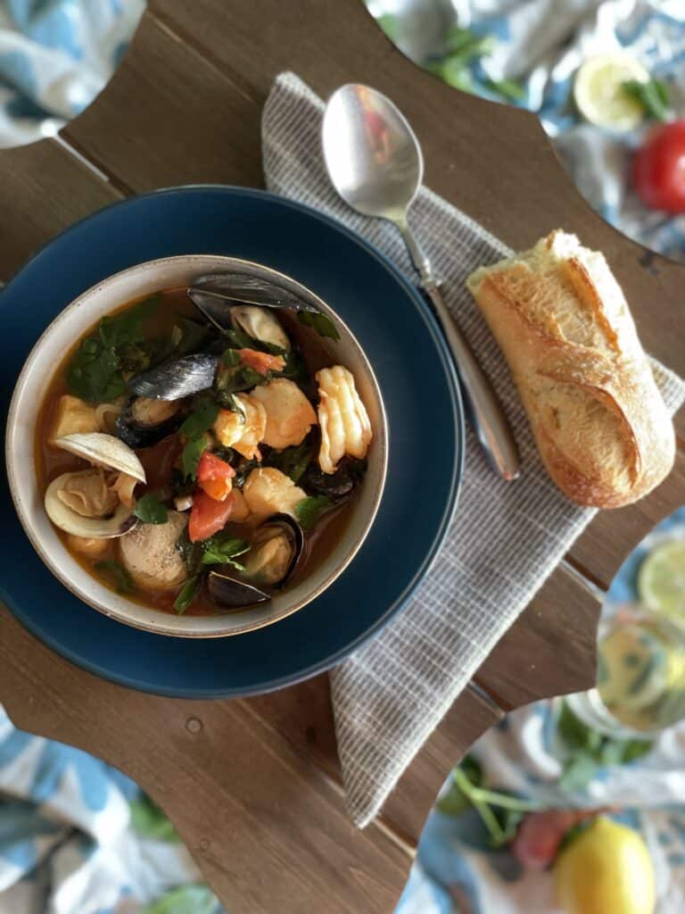 Photo of delicious cioppino next to rustic bread for dipping