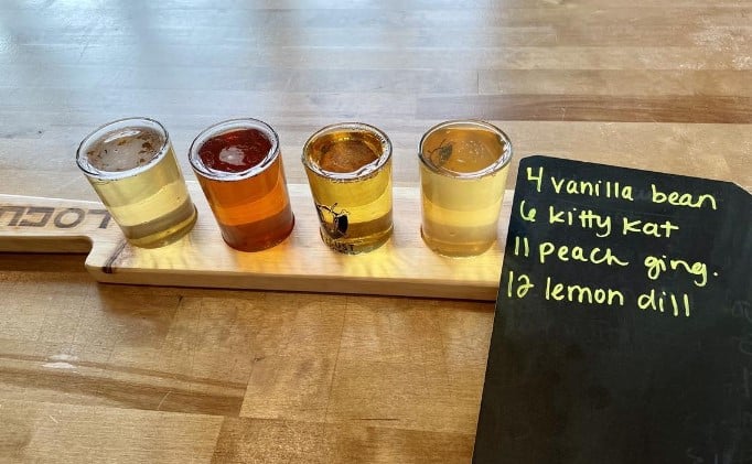 Photo of the rotating seasonal ciders from Locust, including a small sample of their dill cider.