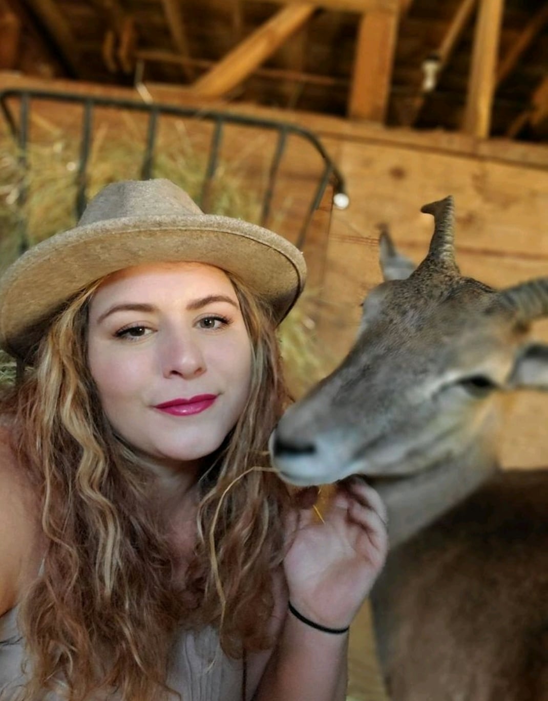 Jessica of @onalaskafarmsanctuary with a deer