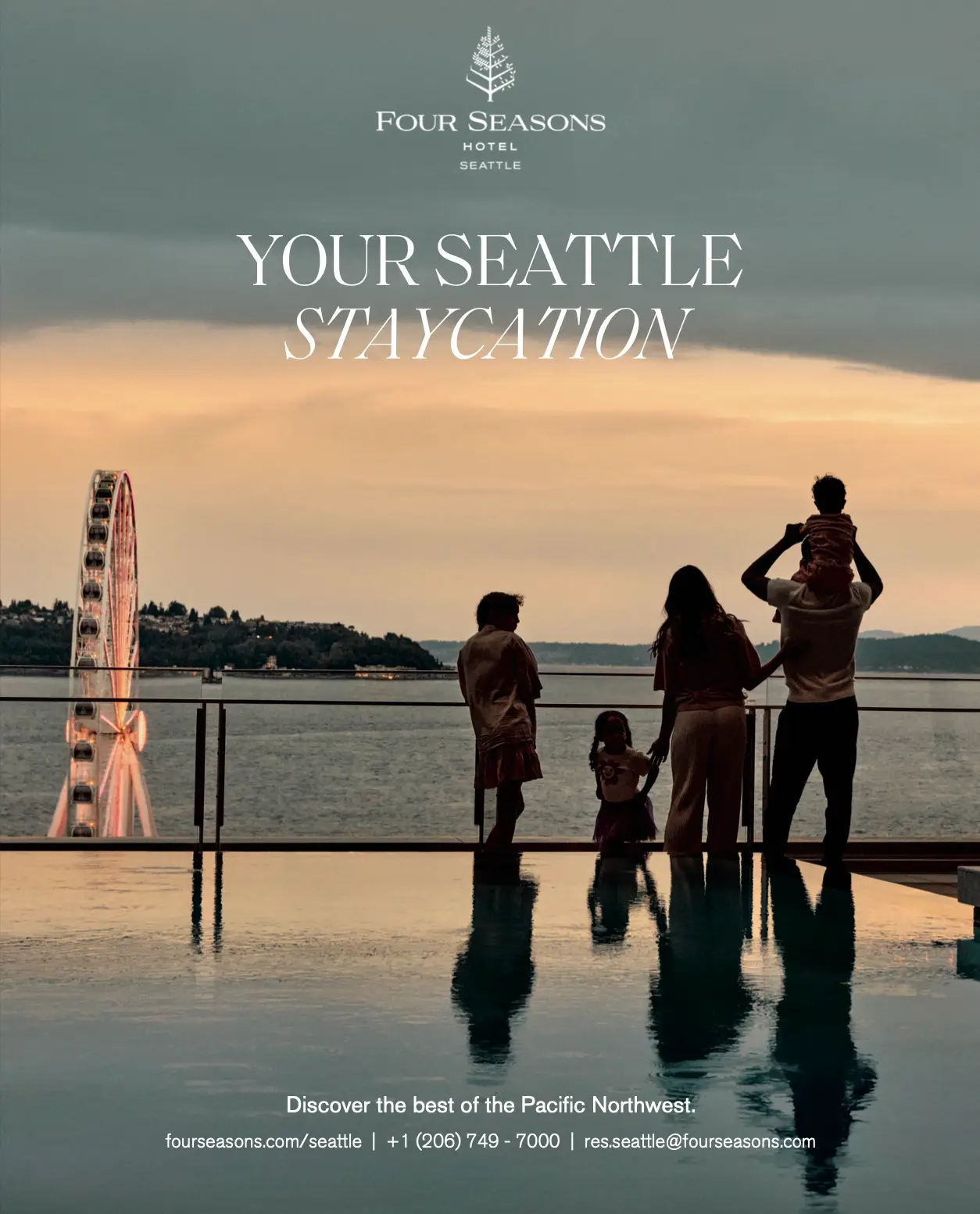 https://trendingnorthwest.com/fourseasons - Four Seasons Seattle Advertisement - family overlooking Elliott Bay with the great wheel in the background looking serene and beautiful in Seattle.