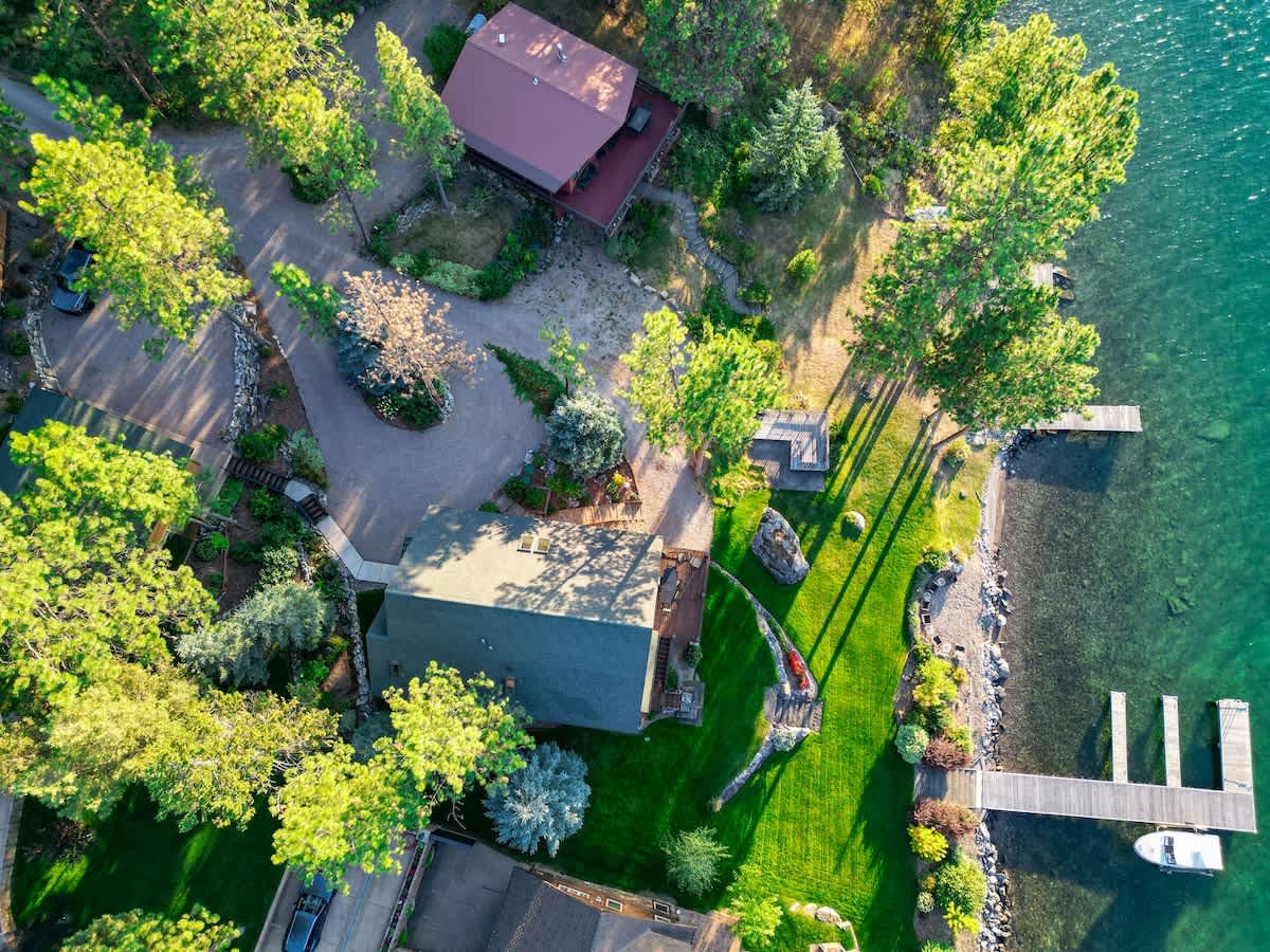 The beautiful home overlooking the water with the sunset.  If you've been hunting for a luxury Montana vacation that will take your breath away, look no further.